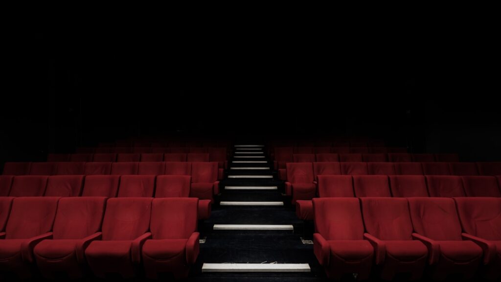 Top Film Distribution Companies in the World 2026: Complete Guide 2 Movie theater audience watching a film — film distribution companies guide