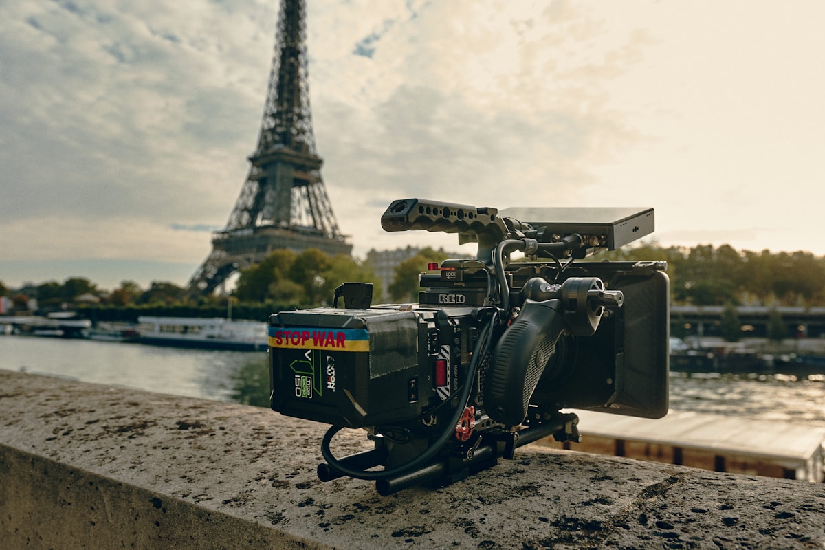Top Production Houses in France 2026: Complete Directory 8 Camera on tripod in front of the Eiffel Tower representing French film production