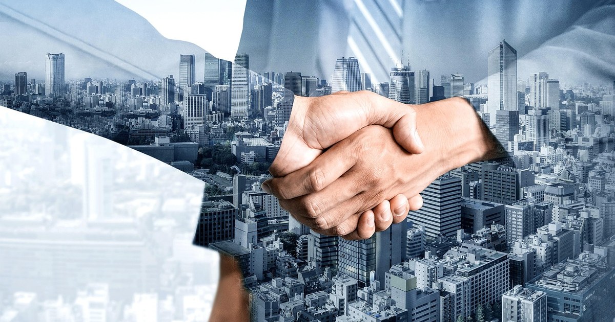 Entertainment Deal Negotiation: A Practical Playbook Across Deal Types 2 Business professionals shaking hands to finalize an entertainment deal negotiation.