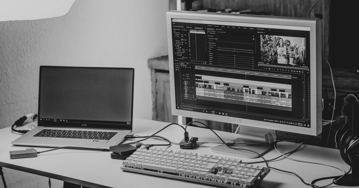 Video editing workstation with dual monitors showing editing software timelines