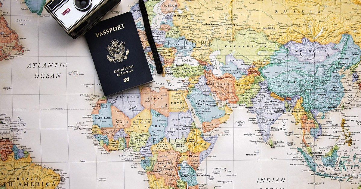 Rights Reversion Clauses and Production Insurance: Two Risks Every Co-Production Needs to Price 2 A passport resting on a folded world map, symbolizing cross-border co-production agreements and rights.