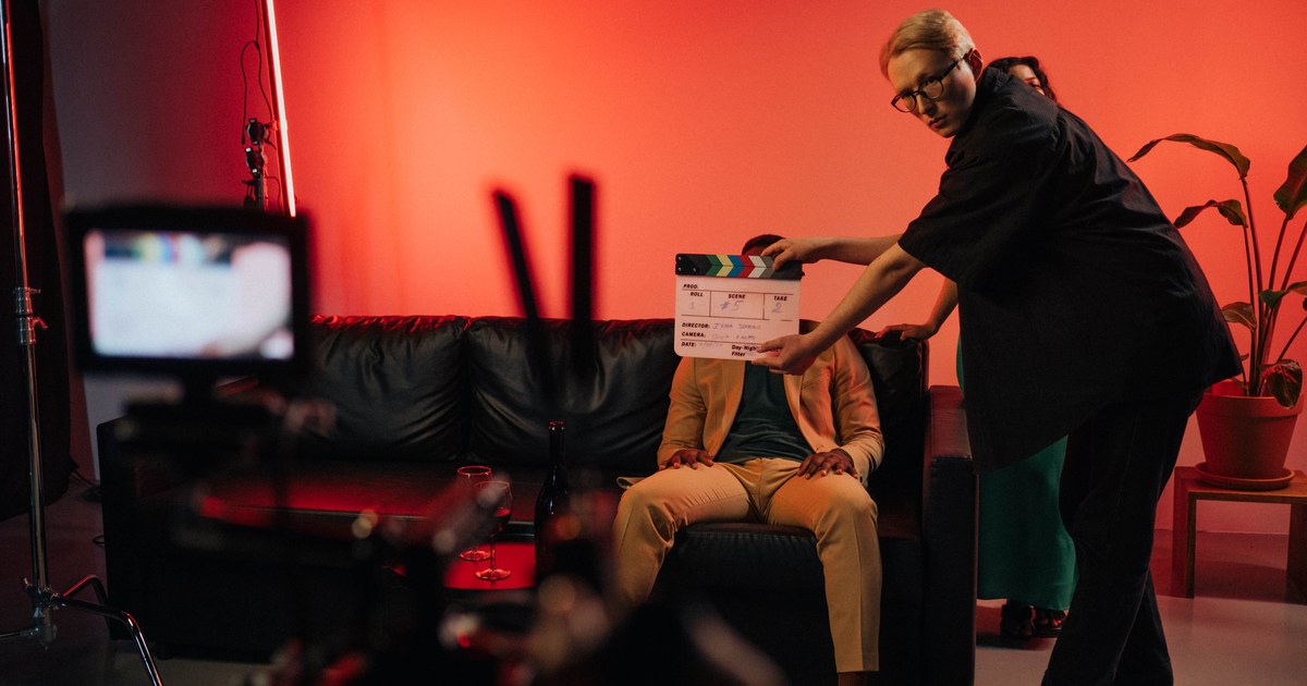 Starz Content Acquisition Strategy: A 2026 Guide 1 Film crew on a drama set with a clapperboard under red lighting, representing Starz's scripted content acquisition and production strategy