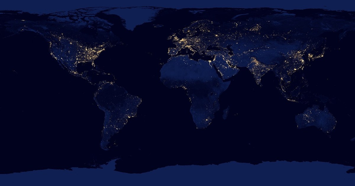 Television Licensing by Territory: How Deal Terms, Buyers, and Content Rules Differ Around the World 2 Satellite view of Earth at night showing illuminated global networks across continents, representing international television licensing by territory.